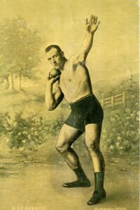 Sepia postcard showing a photograph of AA Cameron shot putting