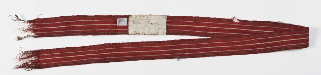 Image of a long strip of fabric. These are red garters